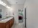 Bathroom with double sinks, granite vanity top and neutral color scheme at 8814 Tuscany Isles Dr, Punta Gorda, FL 33950