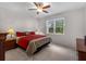 Cozy bedroom featuring a plush bed, side tables with lamps, and a window with a garden view at 8814 Tuscany Isles Dr, Punta Gorda, FL 33950