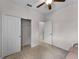 A bedroom features a double door closet, with neutral walls, carpet flooring, and ample natural light at 8814 Tuscany Isles Dr, Punta Gorda, FL 33950