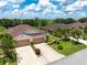 Attractive home exterior with a two-car garage, landscaping, and a well-manicured lawn at 8814 Tuscany Isles Dr, Punta Gorda, FL 33950