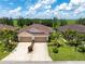 Beautifully landscaped home with a spacious driveway, two-car garage, and lush green lawn at 8814 Tuscany Isles Dr, Punta Gorda, FL 33950