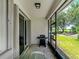 Spacious screened-in lanai with a grill, glass table, and chairs, perfect for outdoor dining and relaxation at 8814 Tuscany Isles Dr, Punta Gorda, FL 33950