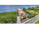 Expansive aerial view of a waterfront condo building with lush landscaping, a driveway, and neighborhood surroundings at 900 E Marion Ave # 1403, Punta Gorda, FL 33950