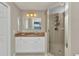 Bathroom features a vanity with a stone countertop and a fully enclosed glass shower at 900 E Marion Ave # 1403, Punta Gorda, FL 33950