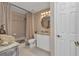 Bathroom featuring a vanity, toilet, tub with shower, and a decorative mirror at 900 E Marion Ave # 1403, Punta Gorda, FL 33950
