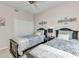 Bedroom featuring two beds, ceiling fan, neutral color palette, and natural lighting at 900 E Marion Ave # 1403, Punta Gorda, FL 33950