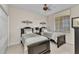 Bedroom featuring two twin beds, dark furniture, ceiling fan, and natural lighting at 900 E Marion Ave # 1403, Punta Gorda, FL 33950
