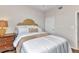 Bedroom with a queen bed, wood floors, and a bedside table with lamp at 900 E Marion Ave # 1403, Punta Gorda, FL 33950