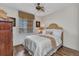 Bright bedroom features wood floors, ceiling fan, blinds, and natural lighting at 900 E Marion Ave # 1403, Punta Gorda, FL 33950