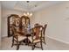 Well-lit dining room features a round wooden table and glass-front hutch at 900 E Marion Ave # 1403, Punta Gorda, FL 33950