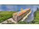 Stunning waterfront condo building showcasing boat docks and architectural details against a serene bay backdrop at 900 E Marion Ave # 1403, Punta Gorda, FL 33950