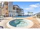 Inviting hot tub beside a sparkling pool, perfect for relaxation and enjoying the serene waterfront views at 900 E Marion Ave # 1403, Punta Gorda, FL 33950