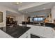 Bright kitchen featuring dark granite countertops and white cabinetry overlooking the living area at 900 E Marion Ave # 1403, Punta Gorda, FL 33950