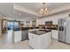 Bright, spacious kitchen with white cabinetry, granite countertops, stainless steel appliances and water view at 900 E Marion Ave # 1403, Punta Gorda, FL 33950