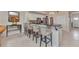 Bright kitchen with granite counters, white cabinets, stainless steel appliances, and bar stool seating area at 900 E Marion Ave # 1403, Punta Gorda, FL 33950