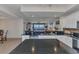 Open kitchen boasts granite counters, stainless steel appliances, white cabinetry, island and views to the living area at 900 E Marion Ave # 1403, Punta Gorda, FL 33950