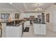Modern kitchen with white cabinets, stainless appliances, dark granite counters and a spacious island with bar seating at 900 E Marion Ave # 1403, Punta Gorda, FL 33950