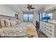 Comfortable main bedroom with a window view, ceiling fan, hardwood floors and stylish decor at 900 E Marion Ave # 1403, Punta Gorda, FL 33950
