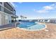 Brightly lit pool surrounded by lounge chairs offers a refreshing escape with palm trees adding a tropical flair at 900 E Marion Ave # 1403, Punta Gorda, FL 33950