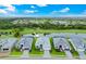 Stunning aerial view of a modern home with lush landscaping and a serene lake view at 14846 Contenta Loop, Bradenton, FL 34211