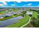 Aerial view of backyard of home on golf course overlooking the pond at 14846 Contenta Loop, Bradenton, FL 34211