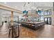 Spacious bar area featuring modern lighting, ample seating, and high ceilings with herringbone-patterned flooring at 14846 Contenta Loop, Bradenton, FL 34211