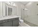 Modern bathroom showcasing a glass-enclosed shower and a vanity with dual sinks and hardware at 14846 Contenta Loop, Bradenton, FL 34211