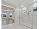 Bathroom featuring glass shower, marble floors and walls, and doorway to bedroom at 14846 Contenta Loop, Bradenton, FL 34211