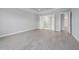Bedroom featuring wood-look tile flooring, neutral walls, and doorways leading to other rooms at 14846 Contenta Loop, Bradenton, FL 34211