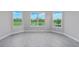 Bedroom featuring wood-look tile floors and large windows with picturesque outdoor views at 14846 Contenta Loop, Bradenton, FL 34211