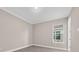 Minimalist bedroom featuring clean lines, wood-look floors, and a window for natural light at 14846 Contenta Loop, Bradenton, FL 34211