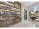 Boutique with a display cabinet featuring beauty products, dark wood door, and stone-look tile floor at 14846 Contenta Loop, Bradenton, FL 34211