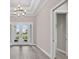 Bright entryway featuring modern chandelier, tiled floors, and doorway to another room at 14846 Contenta Loop, Bradenton, FL 34211