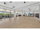 Spacious fitness center with wood floors, mirrors, ceiling fans, weights, and exercise equipment at 14846 Contenta Loop, Bradenton, FL 34211