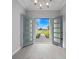 Grand foyer entrance with elegant doors and tile flooring, showcasing a bright and open design at 14846 Contenta Loop, Bradenton, FL 34211