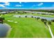Beautiful aerial view of a lush green golf course with ponds and manicured landscaping under a bright blue sky at 14846 Contenta Loop, Bradenton, FL 34211