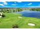Aerial view of a beautiful golf course with trees and a lake with multiple floating greens at 14846 Contenta Loop, Bradenton, FL 34211