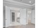 Hallway featuring open doorway leading to a bright bathroom with double doors at 14846 Contenta Loop, Bradenton, FL 34211