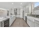 Modern eat-in kitchen with marble countertops, island with bar, gray subway tile backsplash, and stainless appliances at 14846 Contenta Loop, Bradenton, FL 34211