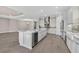 Open concept kitchen with marble island, stainless appliances, gray subway tile backsplash, and gray cabinets at 14846 Contenta Loop, Bradenton, FL 34211