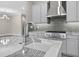 Modern eat-in kitchen with island with sink, marble countertops, gray subway tile backsplash, and stainless gas range at 14846 Contenta Loop, Bradenton, FL 34211