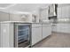 Modern eat-in kitchen with island with stainless beverage cooler, gray subway tile backsplash, and stainless appliances at 14846 Contenta Loop, Bradenton, FL 34211