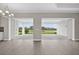 Bright living room with sliding glass doors opening to a covered patio, showcasing picturesque pond views at 14846 Contenta Loop, Bradenton, FL 34211