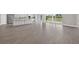 Open-concept space with tile flooring, seamless transitions to the kitchen and access to outdoor views at 14846 Contenta Loop, Bradenton, FL 34211