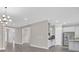 Bright living room with modern chandelier, open floor plan, and elegant gray wood-look floors at 14846 Contenta Loop, Bradenton, FL 34211