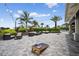 Outdoor patio with comfortable seating areas, string lights, lush landscaping, and a view of the pool area at 14846 Contenta Loop, Bradenton, FL 34211