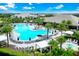 Expansive community pool area with lounge chairs and lush tropical landscaping at 14846 Contenta Loop, Bradenton, FL 34211