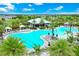 Aerial view of an inviting community pool surrounded by palm trees, lounge chairs, cabanas and a snack bar at 14846 Contenta Loop, Bradenton, FL 34211