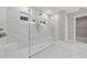 Large, glass-enclosed shower featuring marble surround and dual shower heads at 14846 Contenta Loop, Bradenton, FL 34211