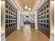 Wine cellar showcases wood floors, a brick barrel ceiling, and individual wine lockers on each side of the hall at 14846 Contenta Loop, Bradenton, FL 34211